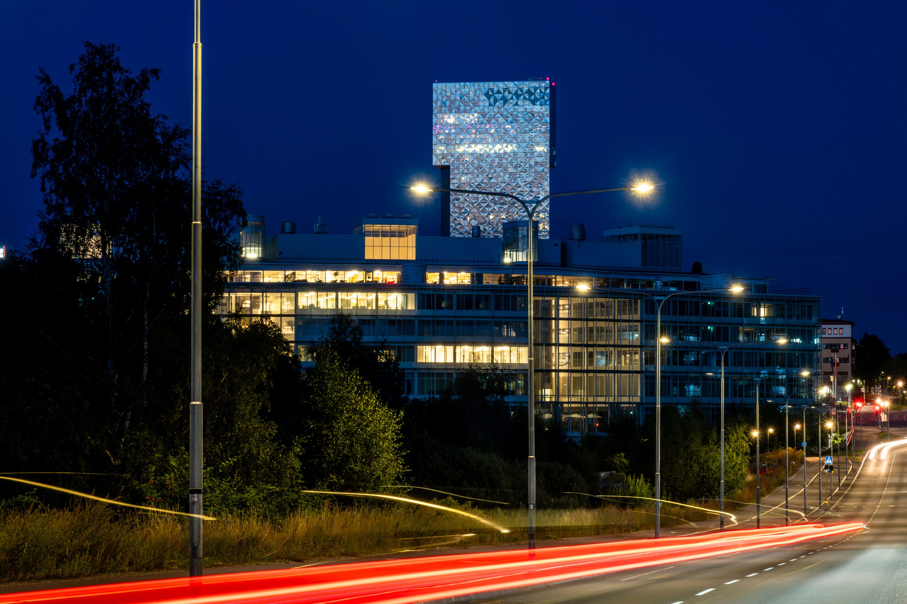 Stockholm, Sweden A night view of the Victoria Tower in the Kista suburb and red traffic streaks.