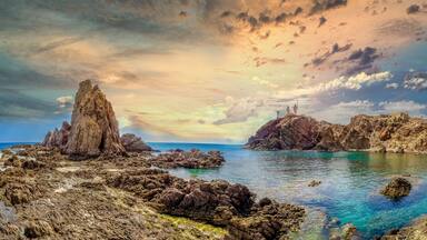 Panoramic view from the Arrecife de las Sirenas in Cabo de Gata, Spain. Sunset in Seascape with reefs and clouds