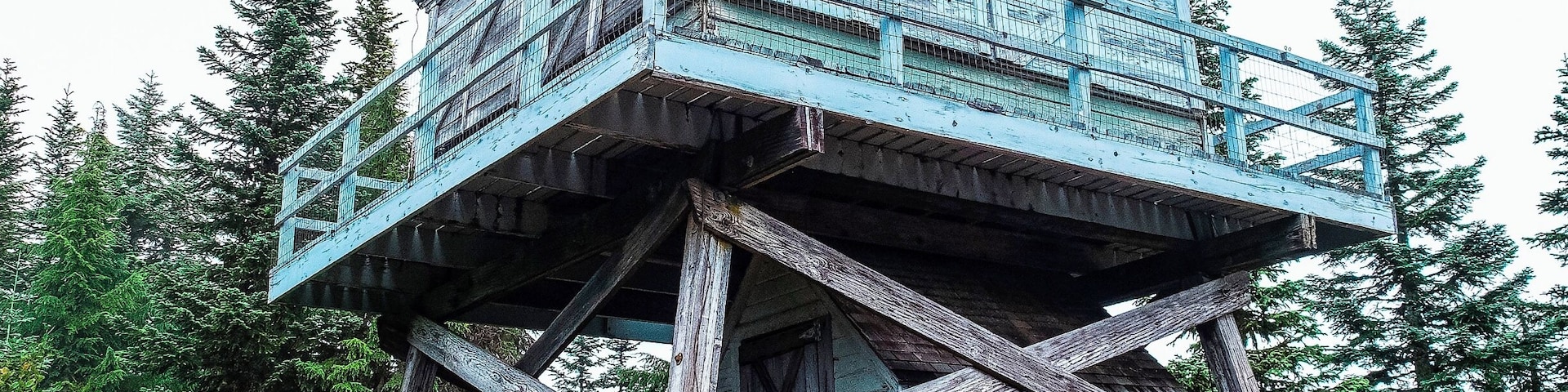 Those of you who were reading my discoveries back in March will recall a rather...um...extended discussion about the battle my partner and I had with the Cold Creek Trail leading to Devil's Peak.
We fought the snow, downed timber and five times losing and re-finding the trail only to have to stop about a half-mile from the end; hip deep in snow and a bit forlorn and defeated.
Well, today we returned to the Cold Creek Trail. There is no snow on the ground, but with a 2,300-foot elevation in a little more than three and a half miles, it managed to whoop us pretty well anyway.
Still, the bete noir is vanquished. The hill has been climbed.
I'll have more on this in the near future, but for now, take a gander at the fire lookout at the summit. No longer active, it is still maintained (by whom, I can't tell you), and serves as a first-come-first-served camping spot, fully equipped with cots, a wood stove, and a ukulele.
Yeah, that's what I said: a ukulele.