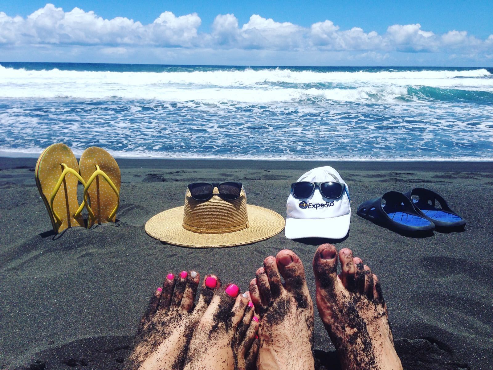 Private beach for Newlyweds.

My wife and me owned this beach for all morning as no one showed up at the beach until noon. The beach looks very beautiful and is a very good place to relax after coming down into the valley, but be careful with going into the water. This beach is known for its rip currents and high surf, making it a dangerous place to go swimming especially during the winter months.

Getting down into Waipi’o Black Sand Beach.

The road down to the beach is one of the steepest roads on the island. On the steepest part, it rises 800 ft in only 0.6 miles. To get down to the valley floor you must either have your own 4WD car, hike down, or hitchhike down. Some Hawaiian car rental companies explicitly mention in the rental agreement that it is not permitted to drive your rental car down into Waipi’o valley, so be sure to ask them if you are allowed to take your car down into the valley. Alternatively, you can join a tour that will take you down to the valley floor.

P.S. Expedia cap and sun glasses were traveling with us:)
#lifeatexpedia