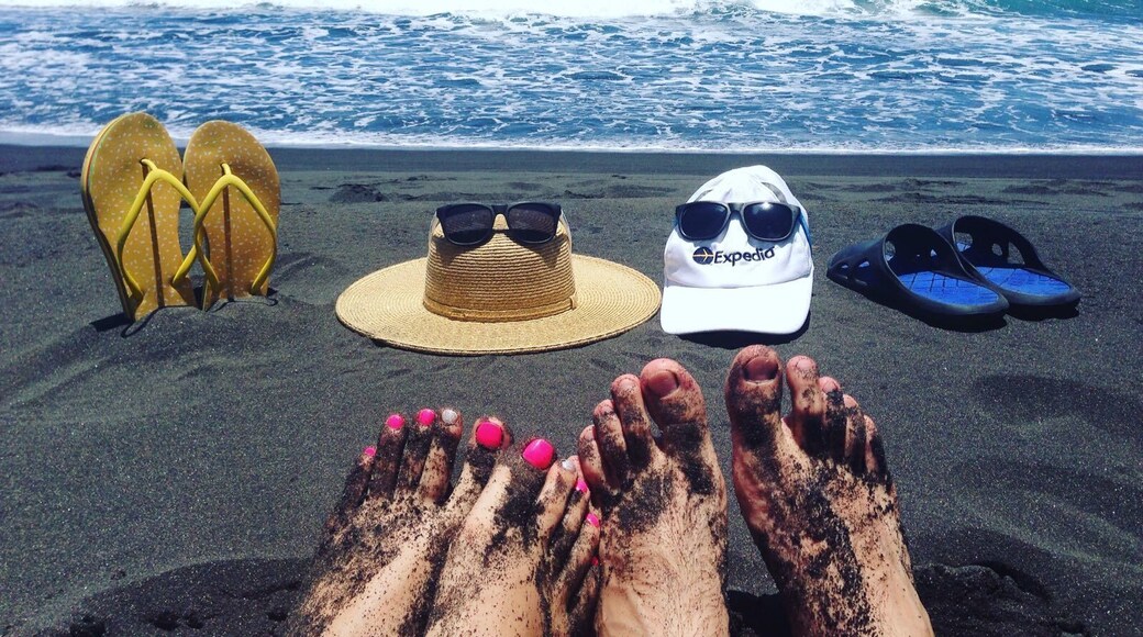 Private beach for Newlyweds.
My wife and me owned this beach for all morning as no one showed up at the beach until noon. The beach looks very beautiful and is a very good place to relax after coming down into the valley, but be careful with going into the water. This beach is known for its rip currents and high surf, making it a dangerous place to go swimming especially during the winter months.
Getting down into Waipi’o Black Sand Beach.
The road down to the beach is one of the steepest roads on the island. On the steepest part, it rises 800 ft in only 0.6 miles. To get down to the valley floor you must either have your own 4WD car, hike down, or hitchhike down. Some Hawaiian car rental companies explicitly mention in the rental agreement that it is not permitted to drive your rental car down into Waipi’o valley, so be sure to ask them if you are allowed to take your car down into the valley. Alternatively, you can join a tour that will take you down to the valley floor.
P.S. Expedia cap and sun glasses were traveling with us:)
#lifeatexpedia