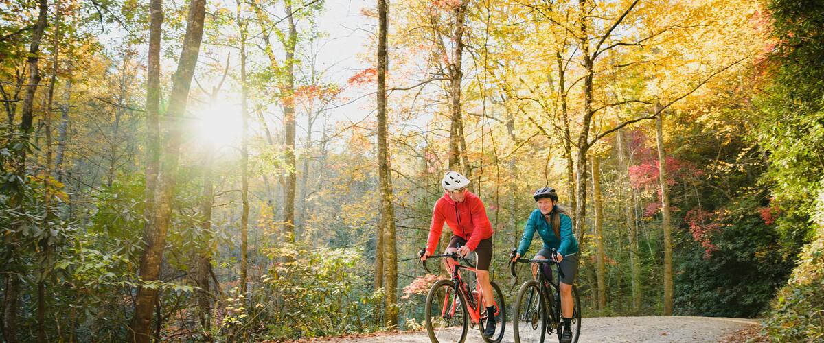 A couple gravel biking near Blue Ridge Parkway in autumn, Pisgah North Carolina
