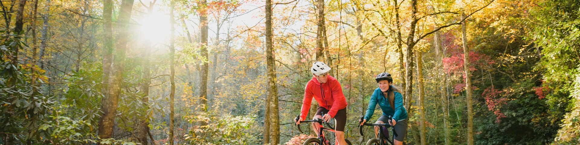 A couple gravel biking near Blue Ridge Parkway in autumn, Pisgah North Carolina