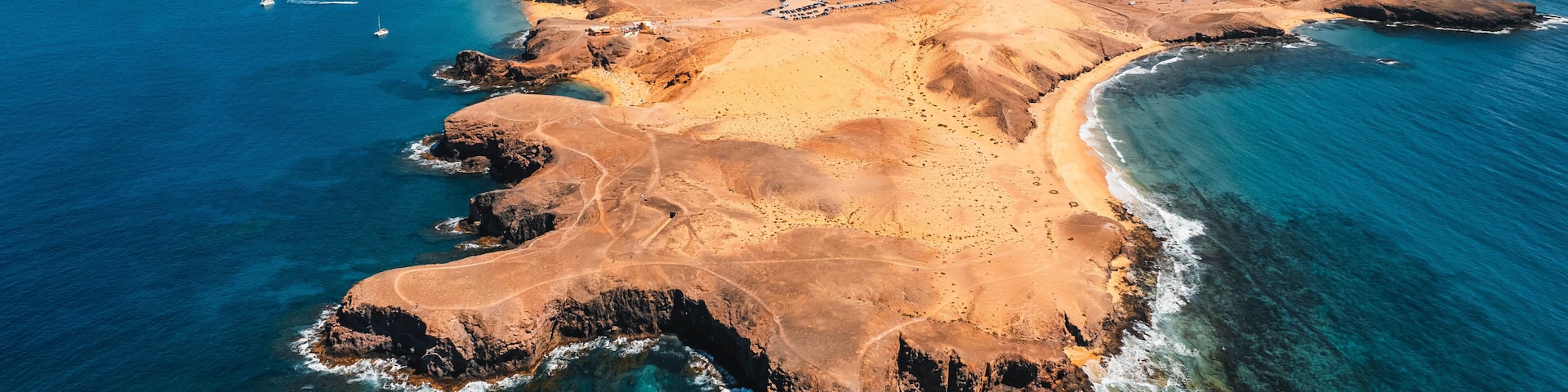Aerial view of the Papagayo beaches near Yaiza featuring turquoise waters, golden sand coves, and volcanic surroundings on the southern coast of Lanzarote