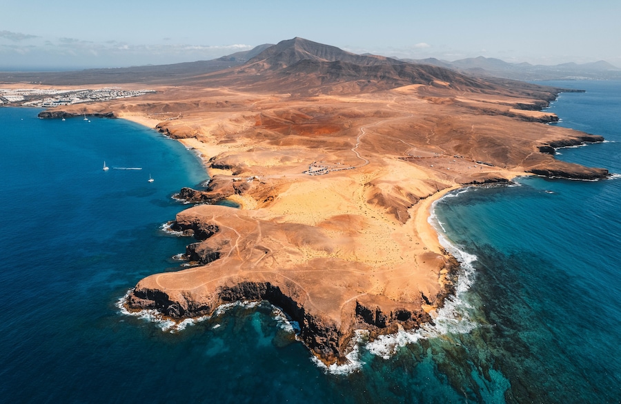 Aerial view of the Papagayo beaches near Yaiza featuring turquoise waters, golden sand coves, and volcanic surroundings on the southern coast of Lanzarote