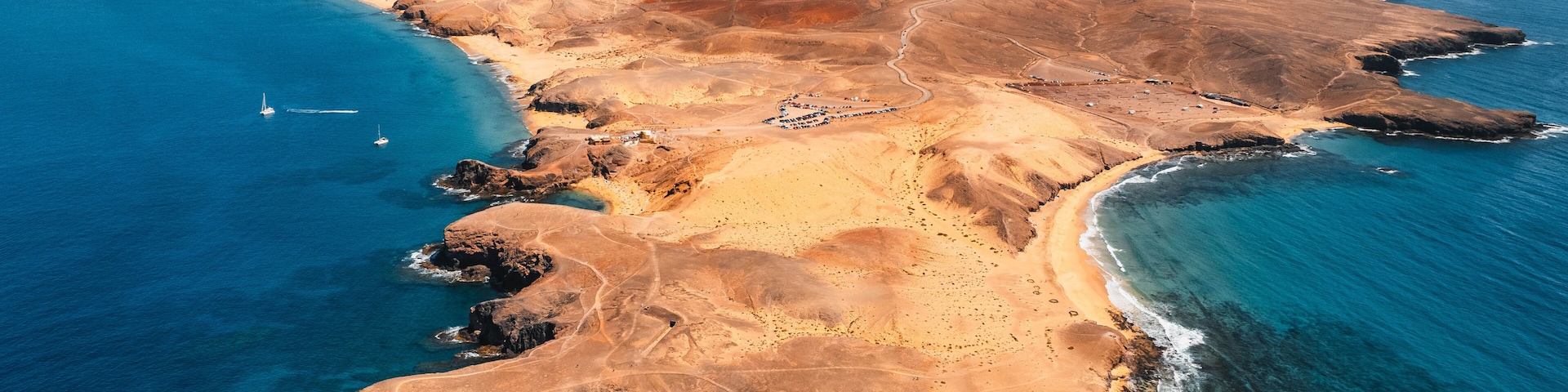 Aerial view of the Papagayo beaches near Yaiza featuring turquoise waters, golden sand coves, and volcanic surroundings on the southern coast of Lanzarote