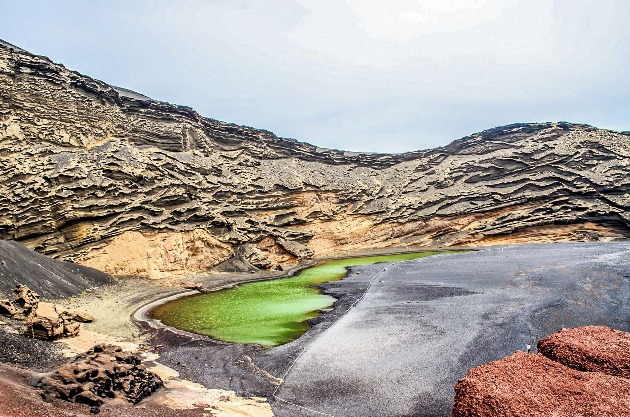 Green coloured lagoon formed from partially collapsed volcano crater.