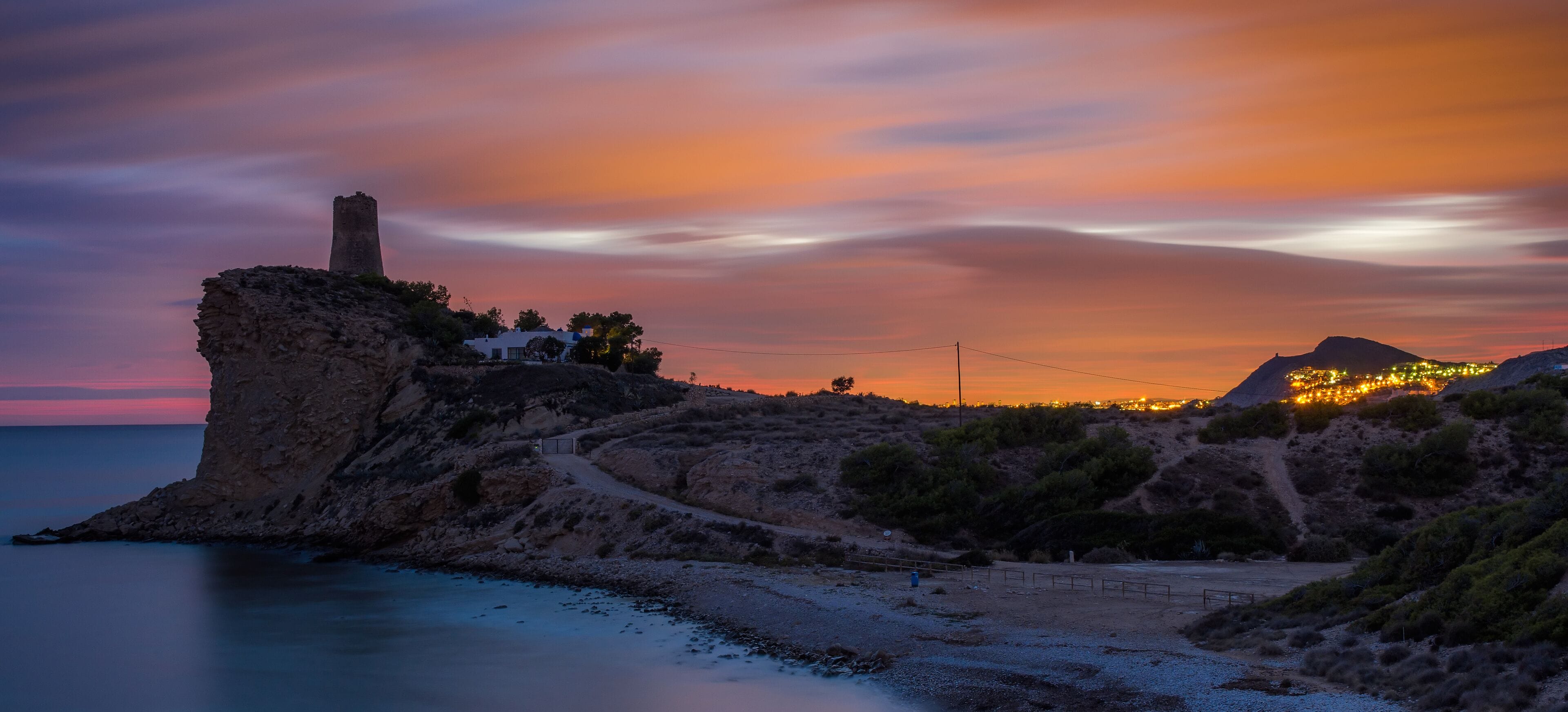 When you see the last light of the sun mixed with the city's lights from a distant and quiet mediterranean beach.