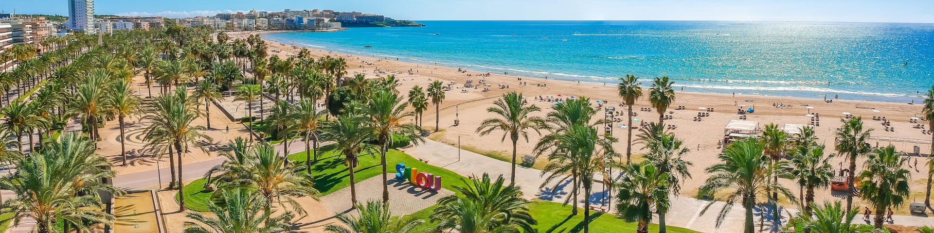 Beach, blue sea and palm trees in Salou city, Catalonia, Spain, Europe