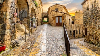 The medieval Spanish village of Pals in the Costa Brava region of Southern Spain as the sun sets after a summer rainstorm.
