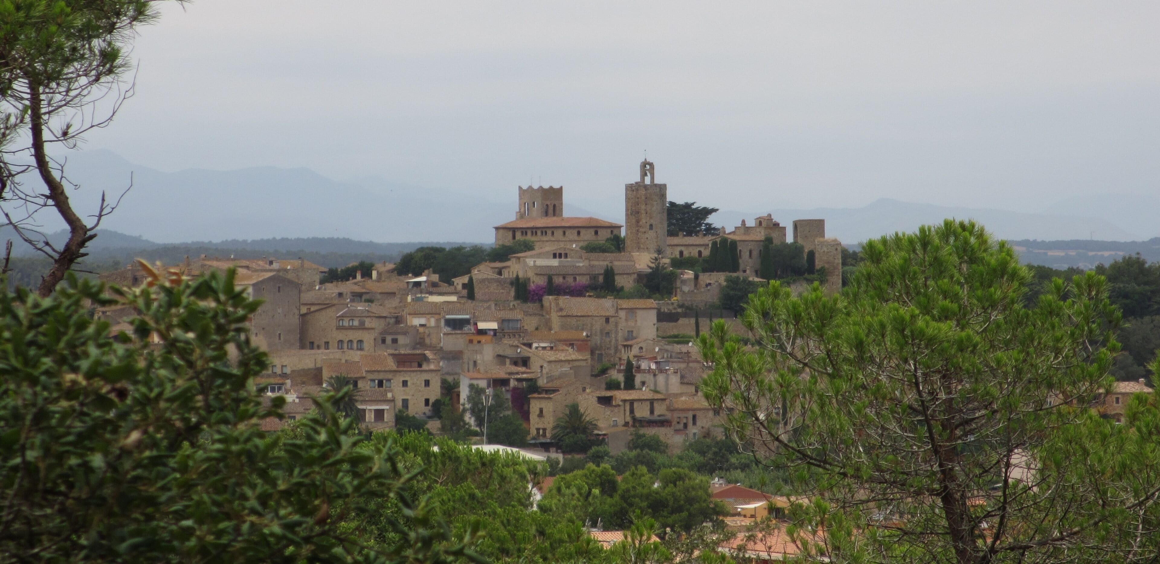 A historic town with medieval architecture, including a prominent tower and a church.