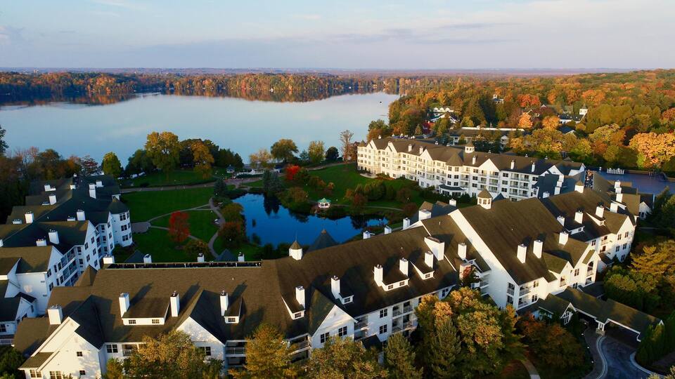 Aerial vista at sunrise over Elkhart Lake, The Osthoff Resort's reflecting pond during colorful autumn, Elkhart Lake, Wisconsin, USA.