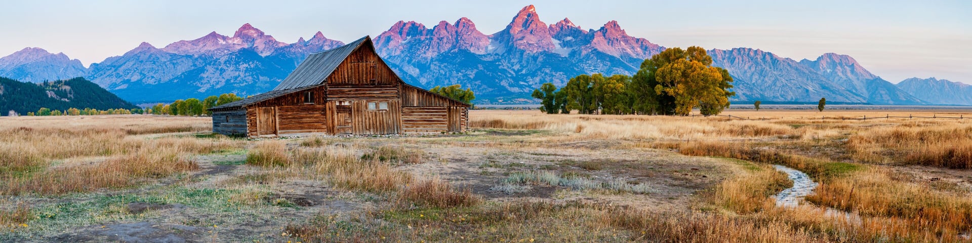 Panorama of the historic mormon barn in front of the Grand Tetons at sunrise, Grand Teton National Park, Wyoming