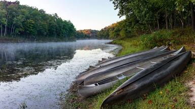 Landscape with canoes stacked on the shore of Lake Lincoln in Cuivre River State Park in Troy, Missouri