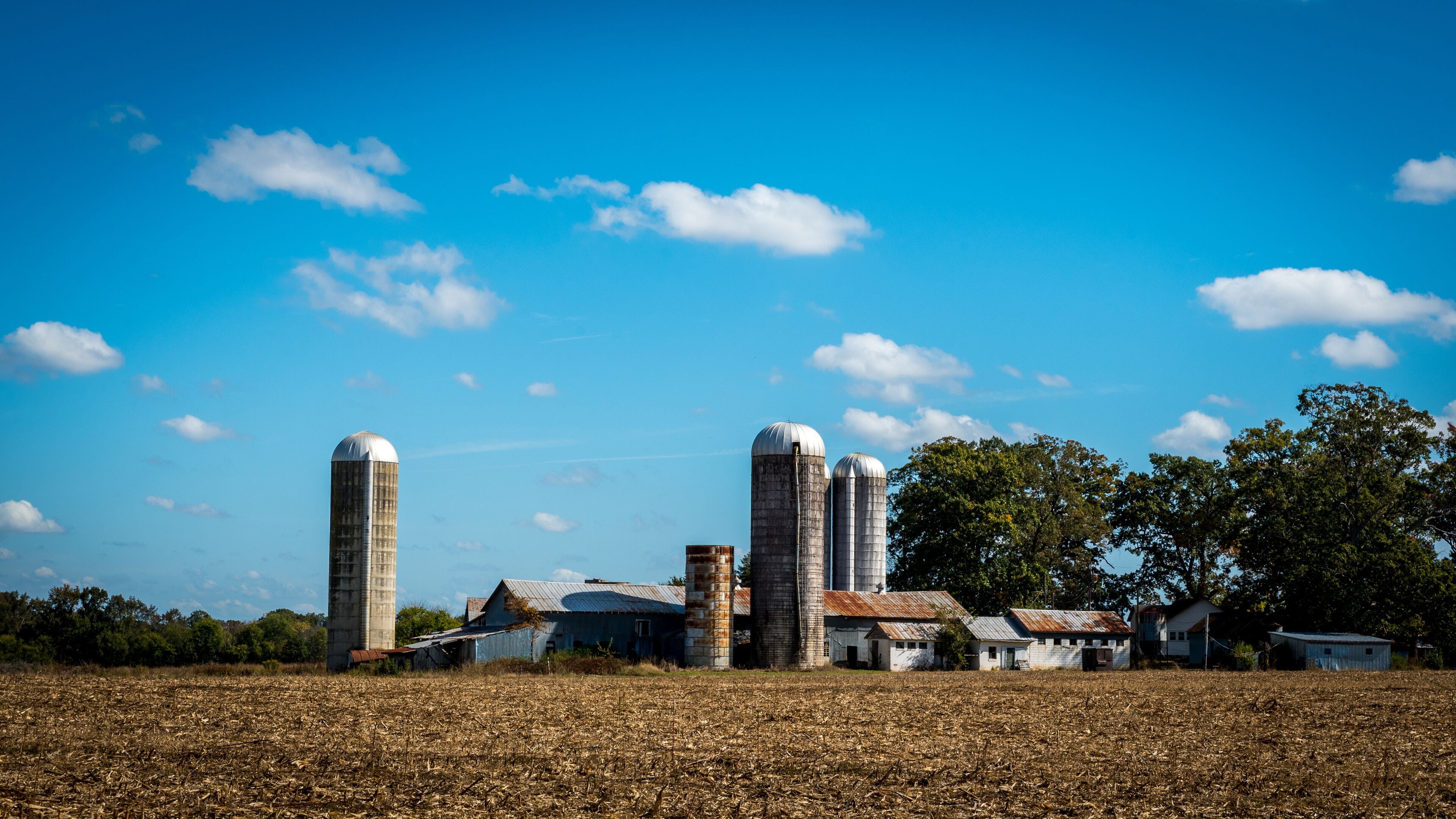 Farm surrounded by a  harvested field