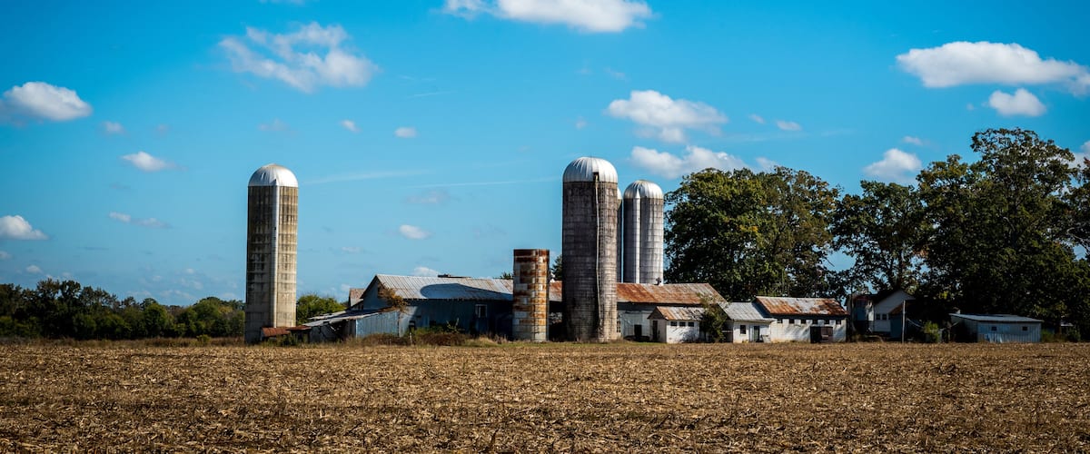Farm surrounded by a  harvested field