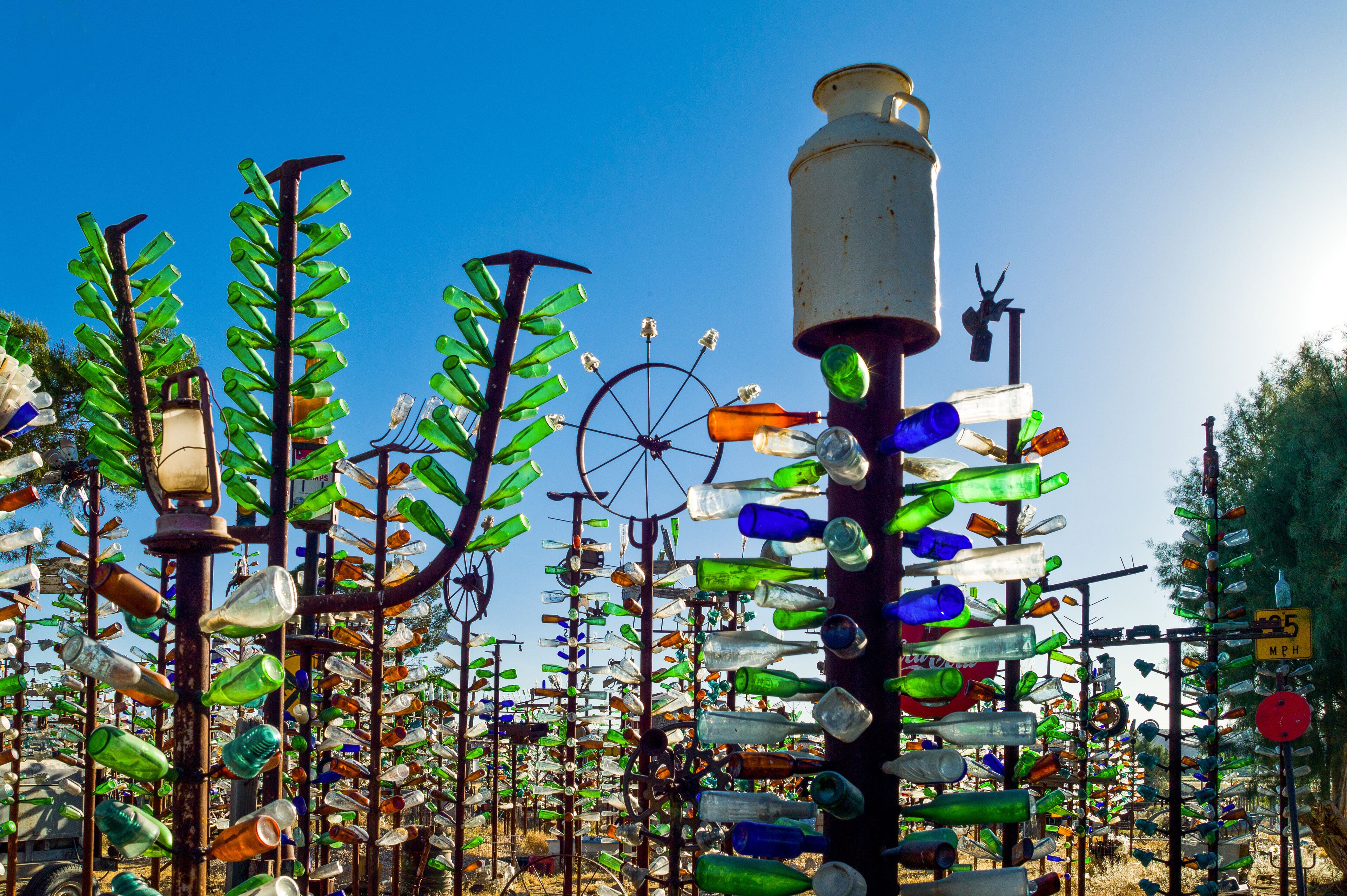 A sculpture garden with various installations made from recycled glass bottles.