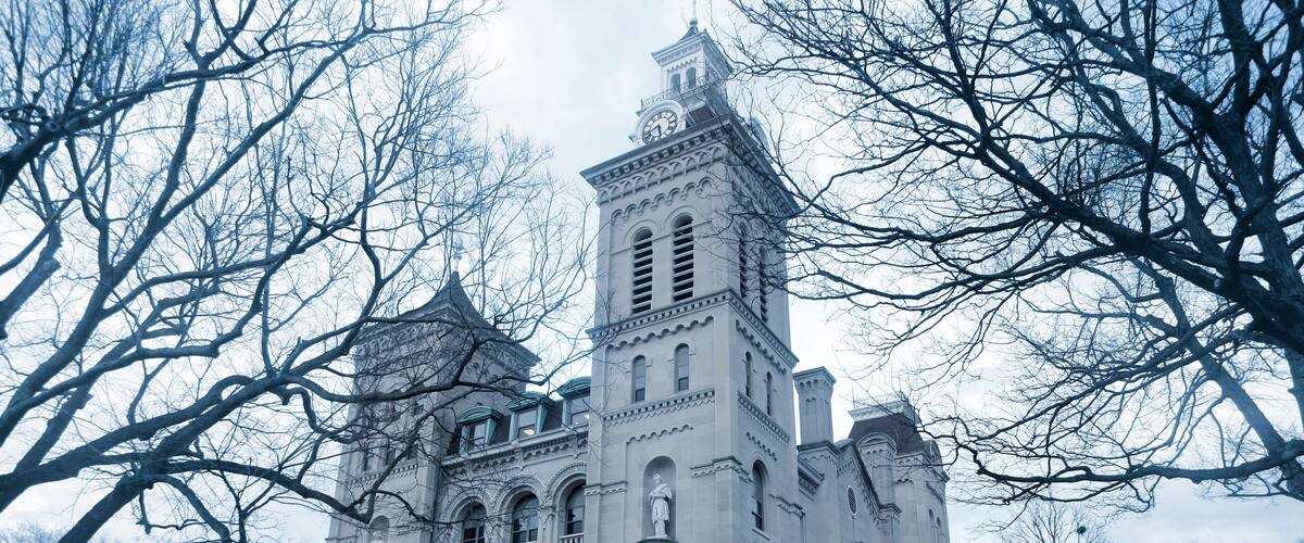 A large, historic building with a clock tower and arched windows.