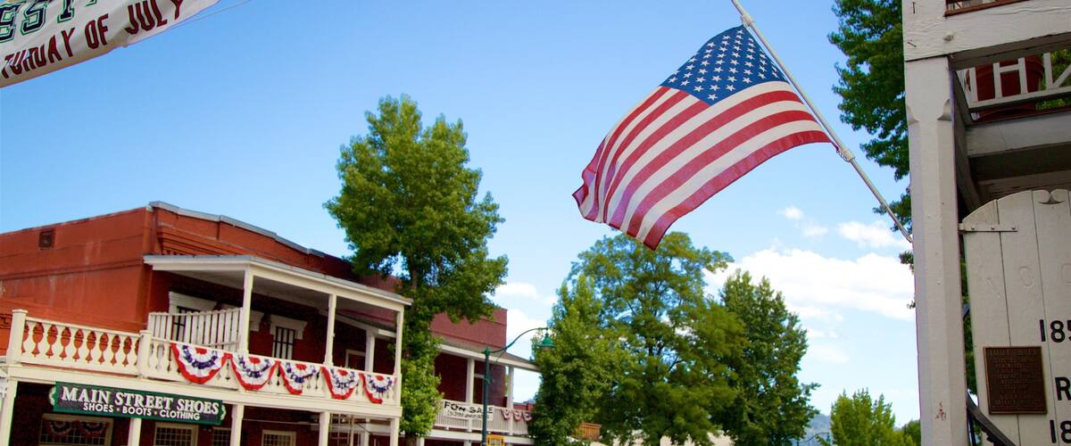 Main Street Shoes store, a white pickup truck, and a large American flag.
