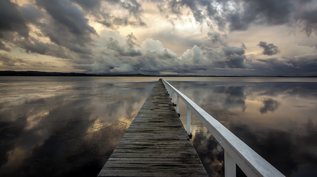 Long Jetty pier near The Entrance on the Central coast during some stormy weather just before sunset.