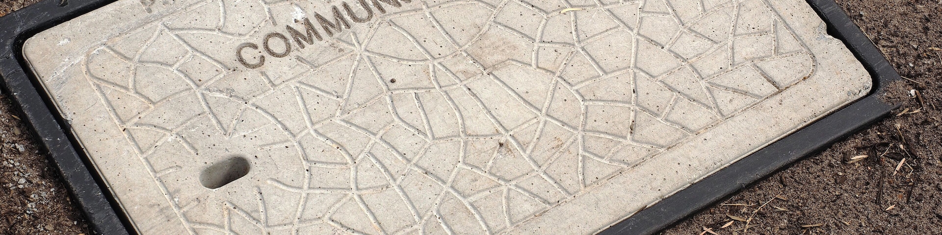 Pit for underground optic fibre communications installation recently installed in the Noble Park residential area, Melbourne, Australia - 2015, March 3