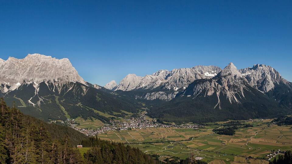 A mountainous landscape with a village nestled in the valley.