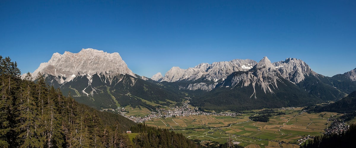 A mountainous landscape with a village nestled in the valley.