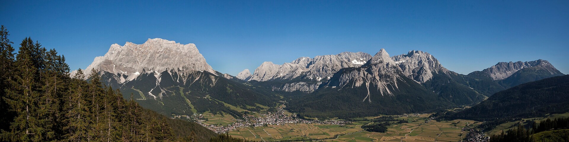 A mountainous landscape with a village nestled in the valley.