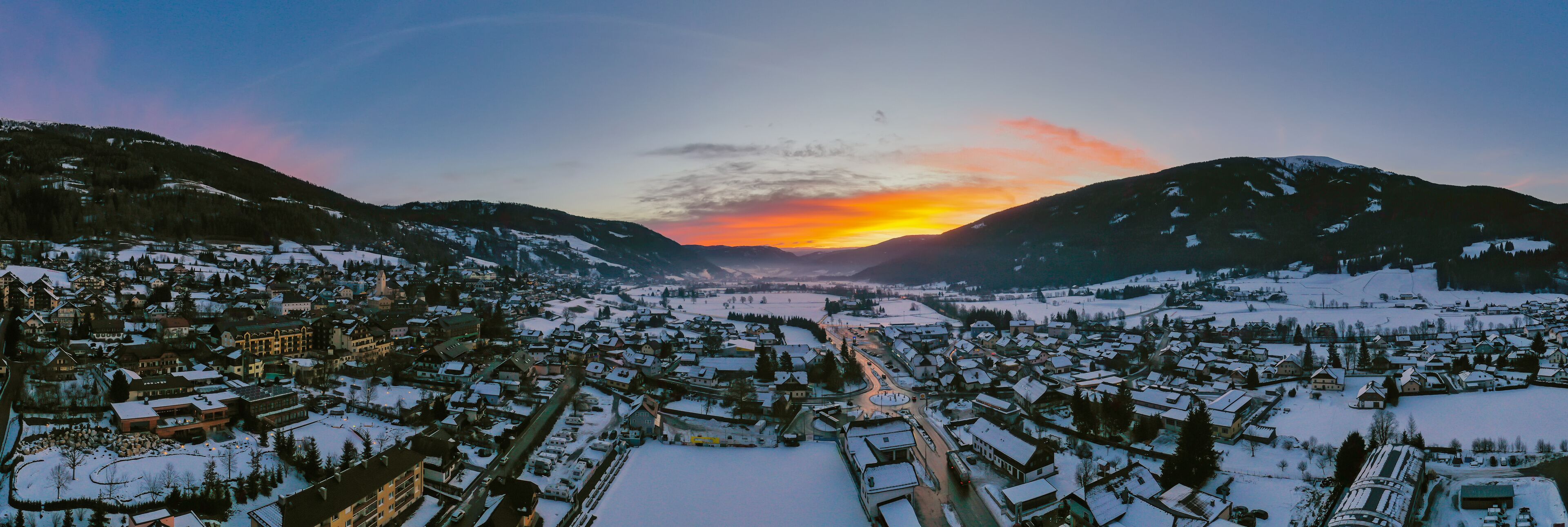 Panoramic view on Sankt Michael im Lungau at sunrise, Austria - January 2020. Aerial drone view.