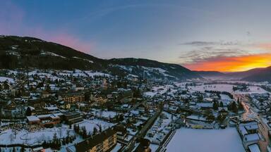 Panoramic view on Sankt Michael im Lungau at sunrise, Austria - January 2020. Aerial drone view.