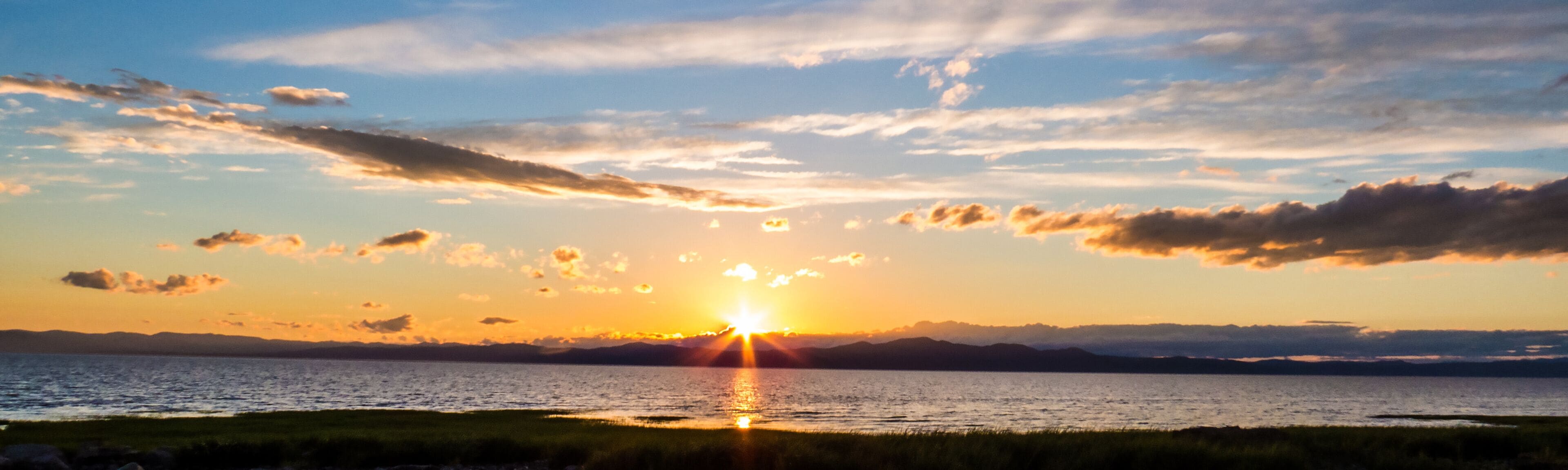 Panorama of a sunset over the mountains and the Saint-Lawrence River. Countryside, Quebec, Canada.