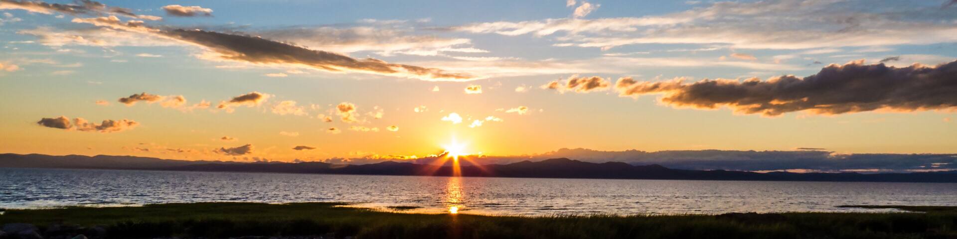 Panorama of a sunset over the mountains and the Saint-Lawrence River. Countryside, Quebec, Canada.