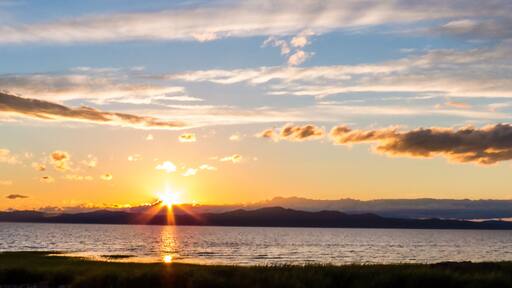 Panorama of a sunset over the mountains and the Saint-Lawrence River. Countryside, Quebec, Canada.