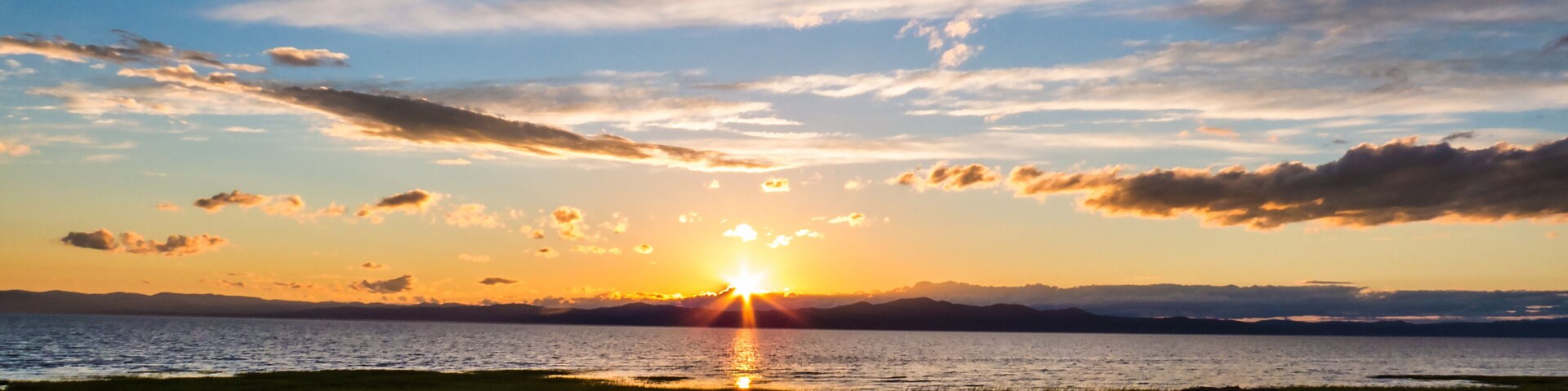 Panorama of a sunset over the mountains and the Saint-Lawrence River. Countryside, Quebec, Canada.