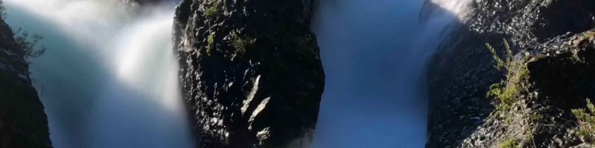 Nice waterfalls with snowcap mountains behind