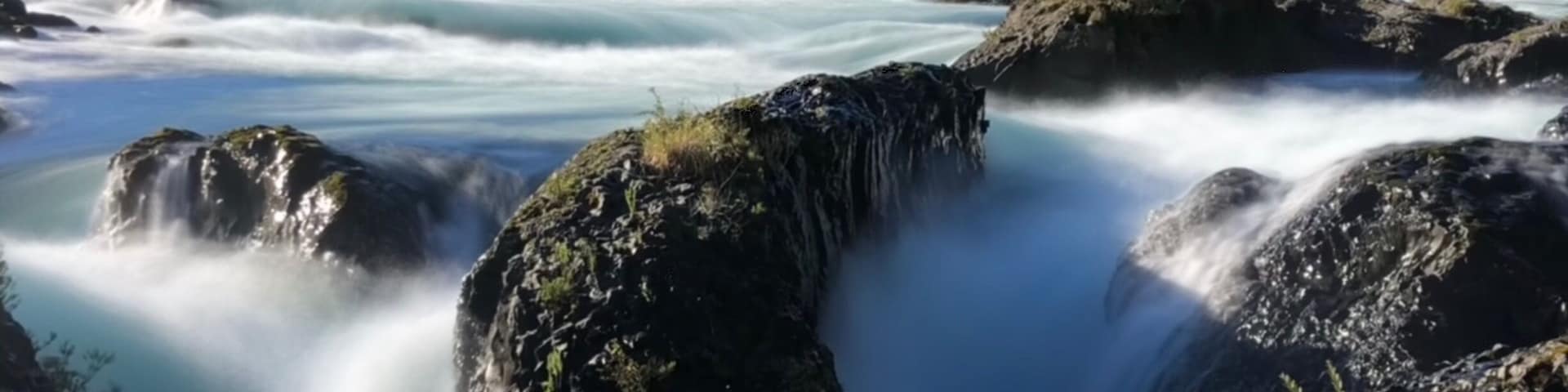 Nice waterfalls with snowcap mountains behind