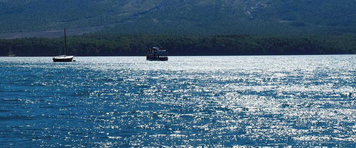 Sailing the "Todo los Santos" Lake with the the snow capped Osorno Volcano (2,652 metres) in the Back