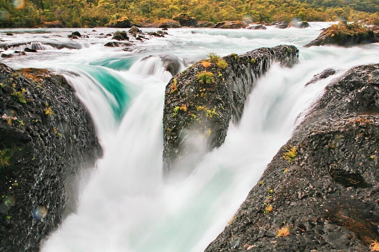 Within Vicente Pérez Rosales National Park the Petrohué River crosses a field of dark, water-worn basalt from Volcan Osorno and forms a series of heavy rapids known as Petrohué Falls.  It's an easy and scenic day trip from Puerto Varas.