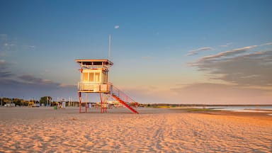 A lifeguard tower on a beach with clear skies.
