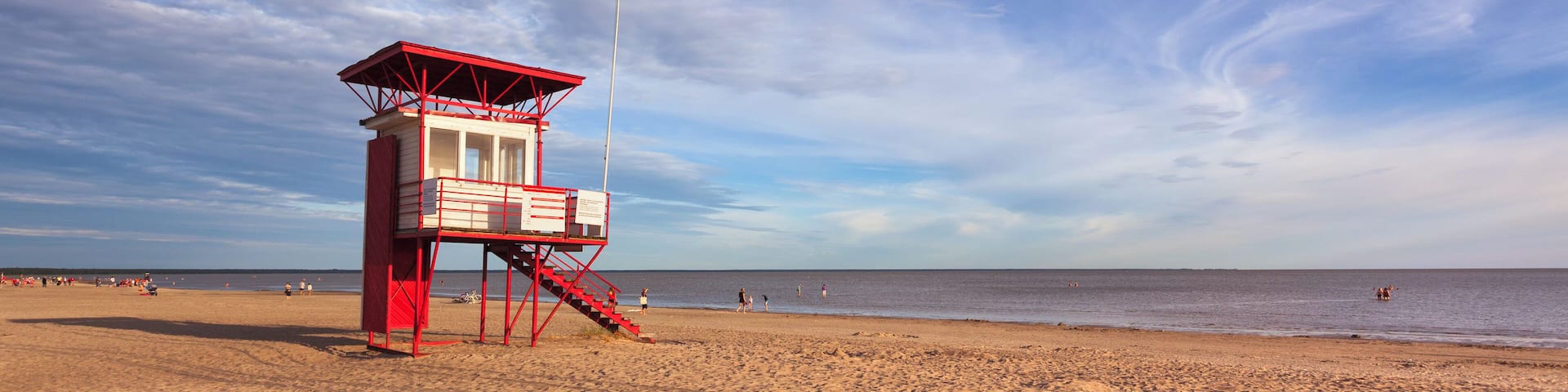 A lifeguard hut on the long and wide sandy beach of P√§rnu, Estonia, in the early evening.