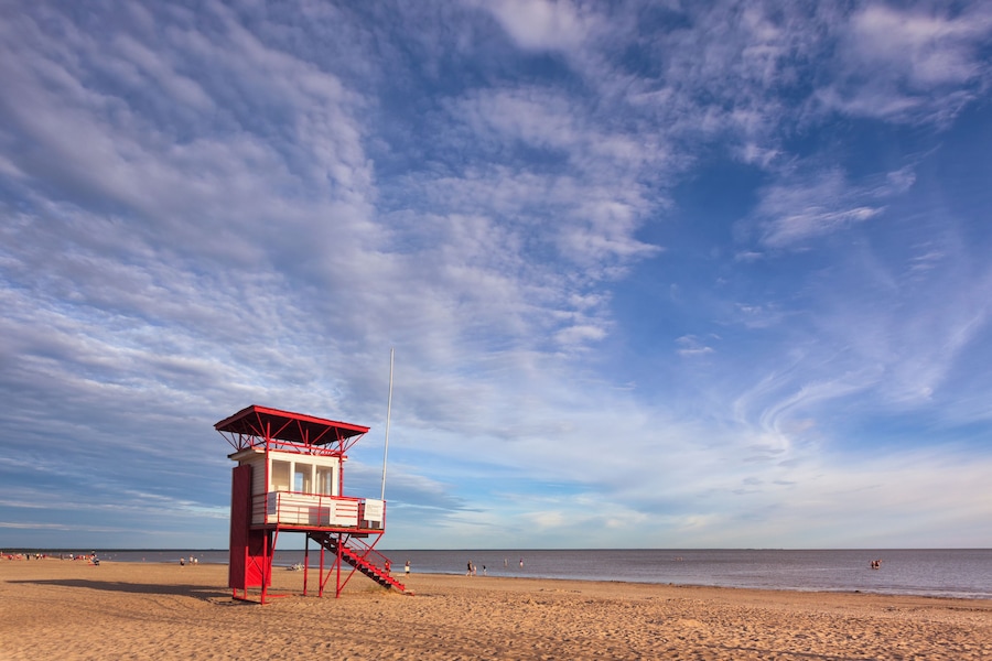 A lifeguard hut on the long and wide sandy beach of P√§rnu, Estonia, in the early evening.
