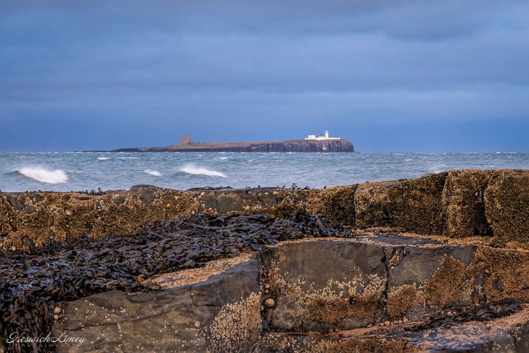 A view of the Farne Islands from the beach at Bamburgh.

These islands are a bird sanctuary that are well worth a visit.
