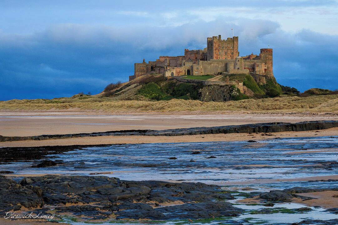 A view of Bamburgh Castle from the beach.

This is a wonderful castle line in the far north east of England.  There are long sandy beaches and a number of castles.  Bamburgh Castle is one of the most impressive as it almost juts out into the sea.