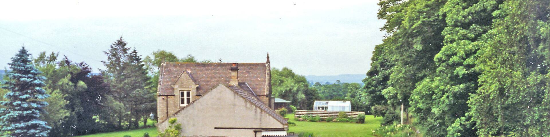 Former station at Humshaugh, 1997. View from the A6320 Low Brunton - Bellingham road, close to its bridge over the River North Tyne at Chollerford, also to the remins of the bridge on the Roman Wall at Chesters milecastle. The station remains, well preserved in private hands, was on the ex-NBR Border Counties line, the view being towards Bellingham, Reedsmouth and Riccarton Junction. The station closed to passengers 11/10/56, when the Newcastle - Hexham - Riccarton Junction service ceased, but goods continued until 1/9/58 (11/11/63 between Bellingham and Reedsmouth).
