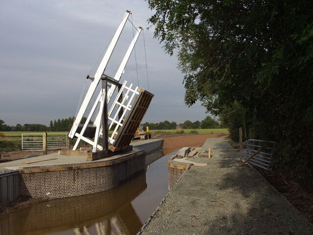Montgomery Canal, every canal lovers dream. Gleaming in white and black paint the new lift bridge on the Montgomery Canal at Morton farm is nearly completed. It is built to the traditional design in oak. It will be used as a cattle crossing for the nearby farm. The water level is slowly rising as water is allowed to seep in at Gronwen wharf.