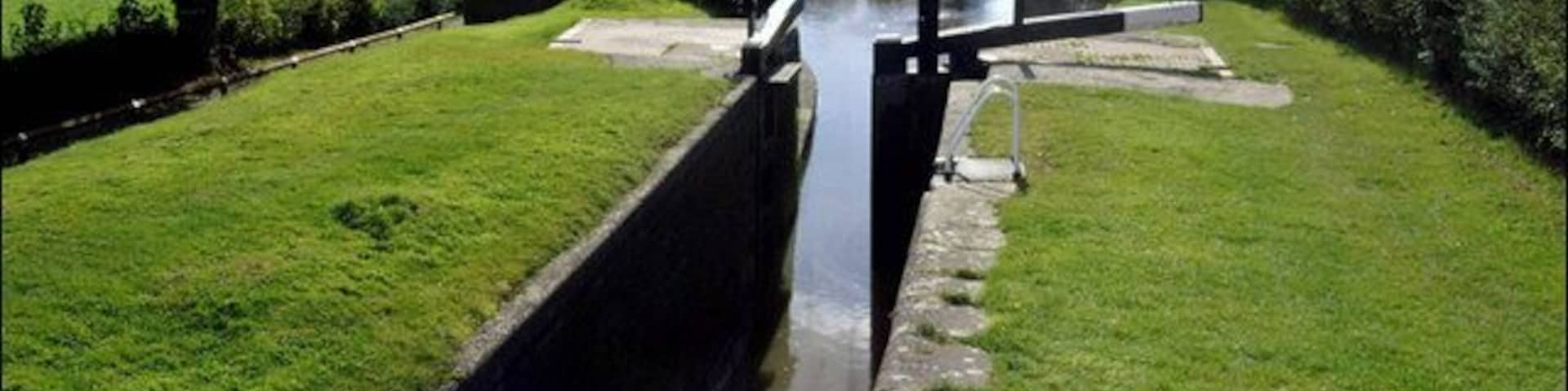 Frankton Top Lock. A view down the Montgomery Canal from just below its junction with the Llangollen Canal. Originally this was in fact the main line of the canal from Ellesmere, which explains why Rowsons Bridge up on the Llangollen Canal, just beyond the junction, has the number 1 on it 130747, even though it is nearly 30 miles from the Llangollen's initial parting with the Shropshire Union Main Line at Hurleston.