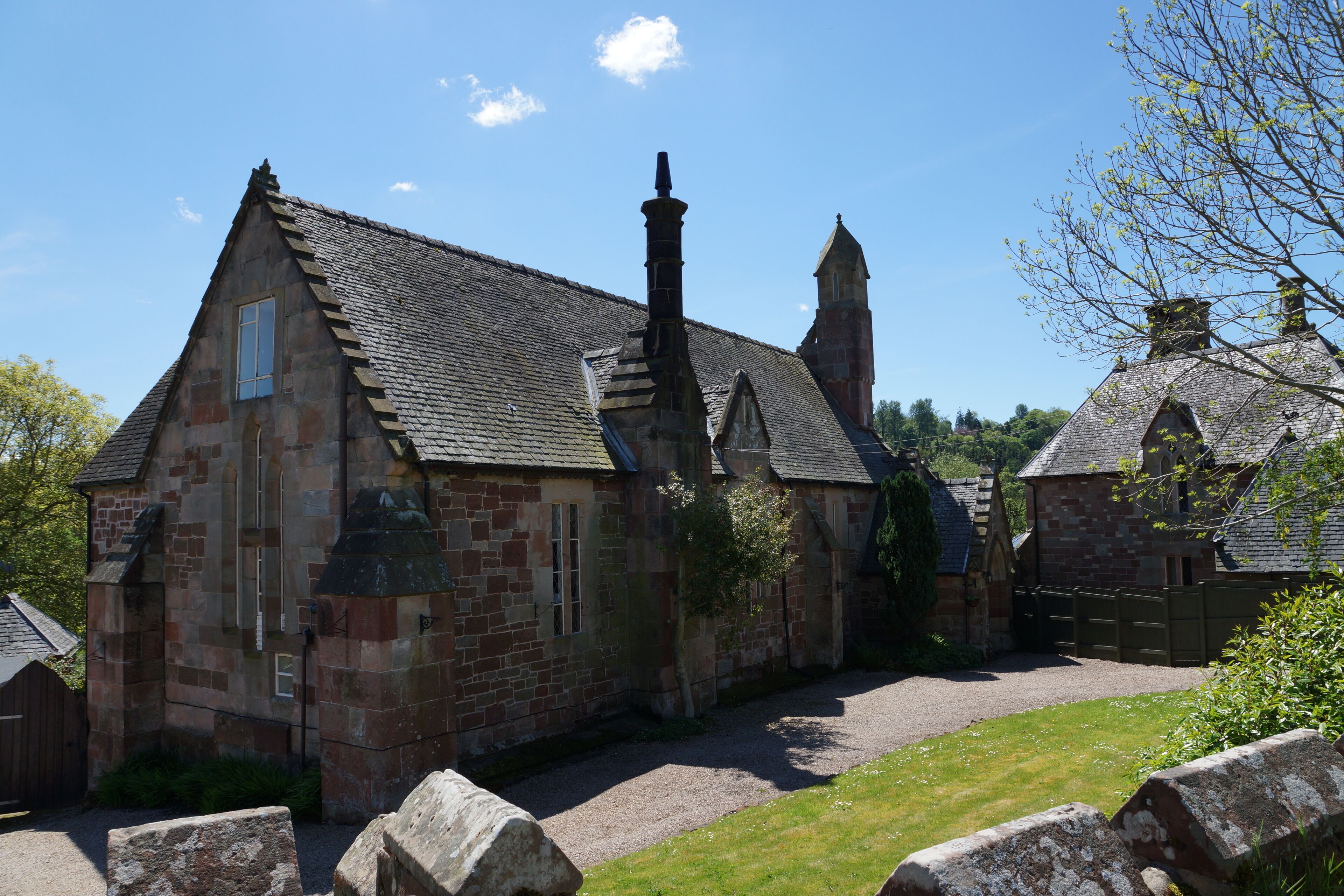 The circa 1850 Grade II listed former School House and Schoolmaster's house (later a post office), both now private houses in Llanyblodwel, Shropshire, England. This is a photo of listed building number 1367153. This is a photo of listed building number 1176996.