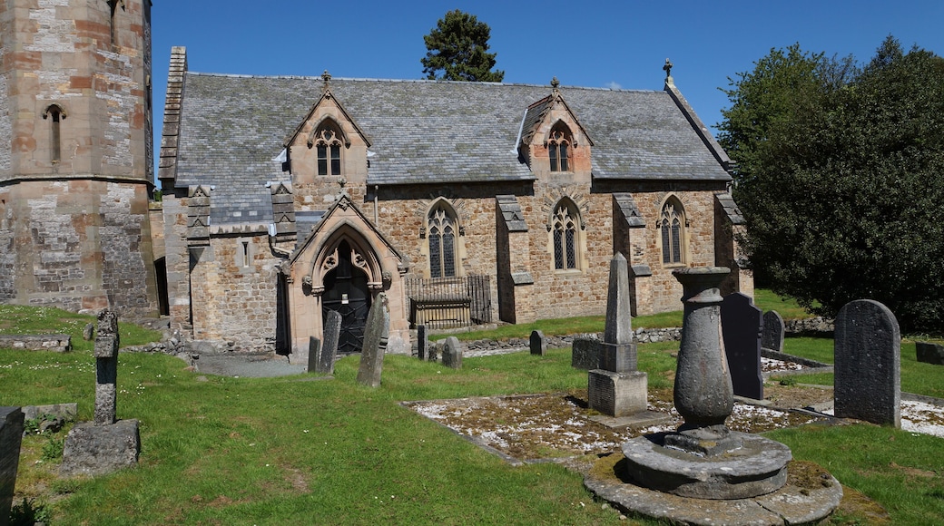 Nave and base of the west tower of parish church of St Michael the Archangel, Llanyblodwel, Shropshire, England. The sundial in the foreground was made in 1712.