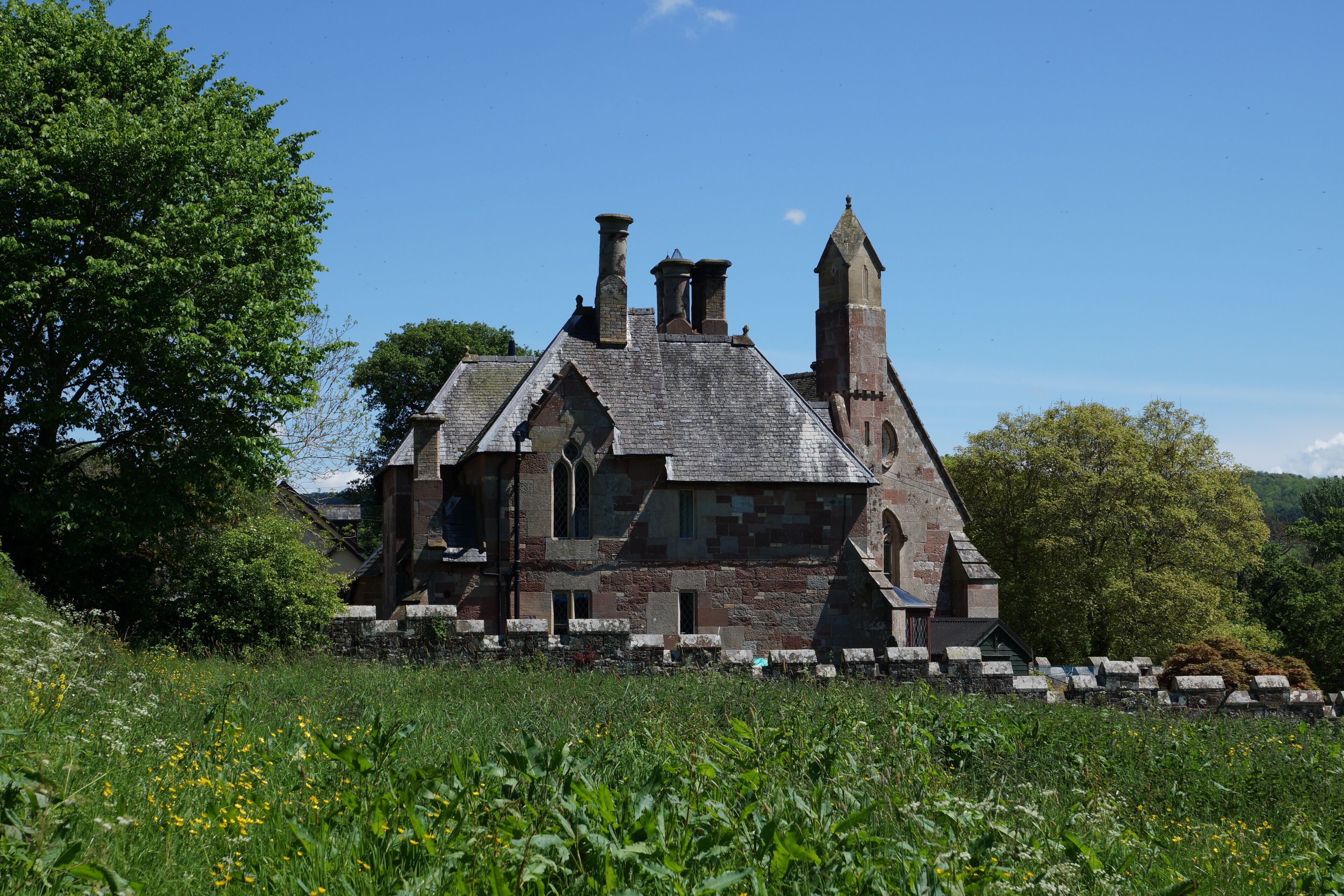 The circa 1850 Grade II listed former School House and Schoolmaster's house (later a post office), both now private houses in Llanyblodwel, Shropshire, England. This is a photo of listed building number 1367153. This is a photo of listed building number 1176996.