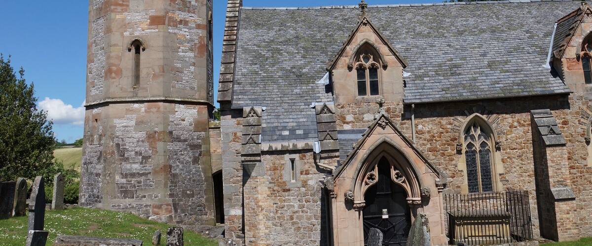 West tower, spire and south porch of the parish church of St Michael the Archangel, Llanyblodwel, Shropshire, England